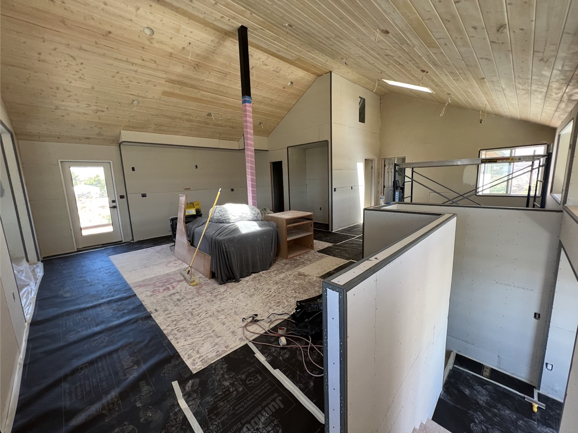 Finished ADU interior with smooth drywall walls and vaulted tongue-and-groove wood ceiling, San Diego