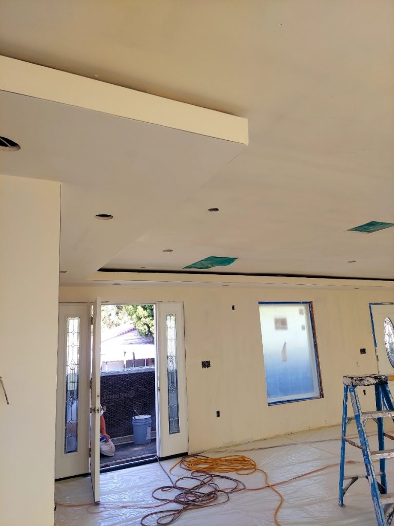 Freshly hung drywall with cutouts made for electrical boxes and recessed lighting in a Mission Hills home