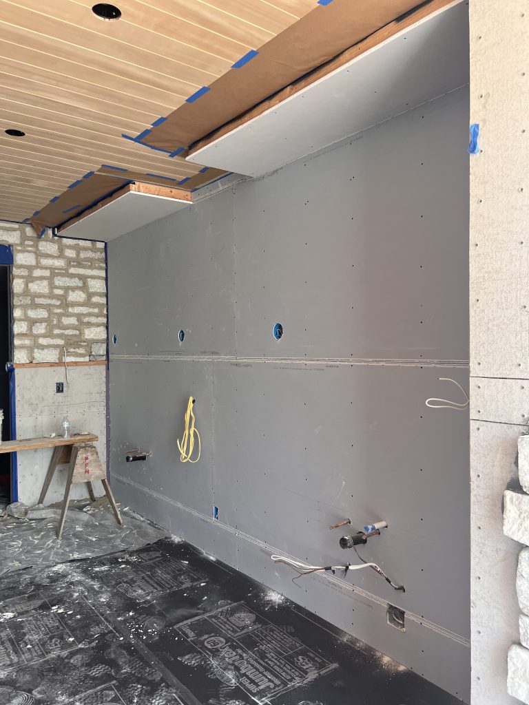 New drywall hung on the walls and ceiling of a garage ADU conversion in Chula Vista