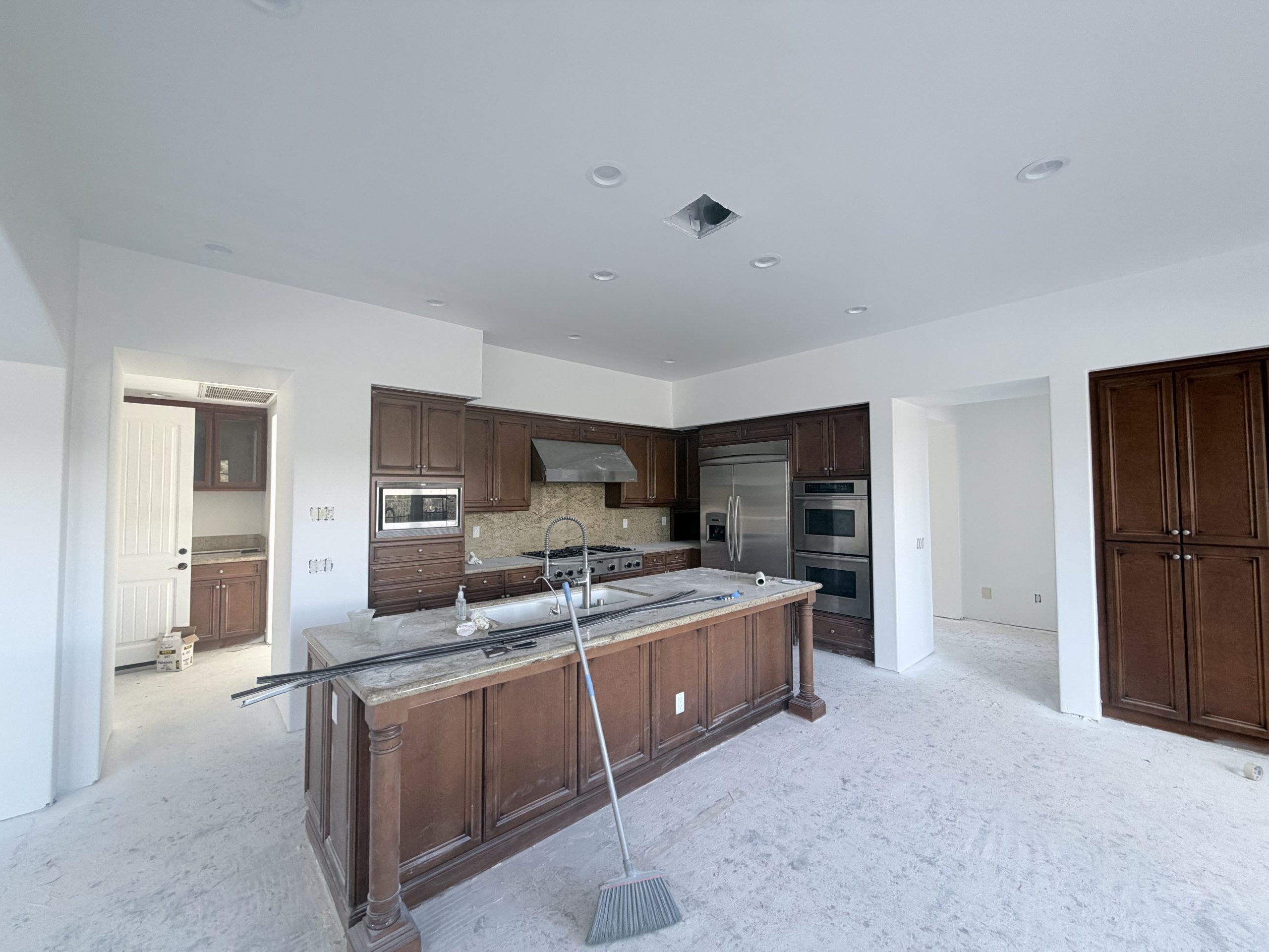 Large kitchen and living area with smooth white drywall throughout, no visible seams, clean corners, Rancho Santa Fe remodel